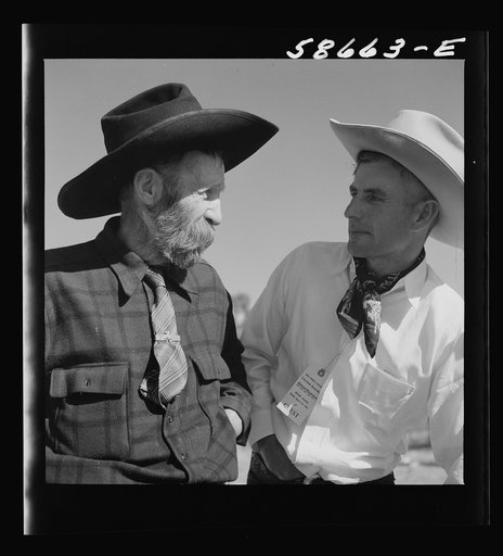 Lyman Brewster of Quarter Circle U Ranch with Turk Greenough's father (Sally Rand's father-in-law) at a stockmen's picnic and barbecue. Spear's Siding, Wyola, Montana