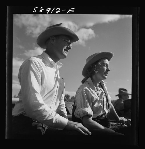Dudes from Quarter Circle U Ranch watching the rodeo at the Crow Indian fair. Crow Agency, Montana