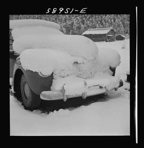 Car covered with snow after early fall blizzard on ranch in mountains rear Aspen, Colorado