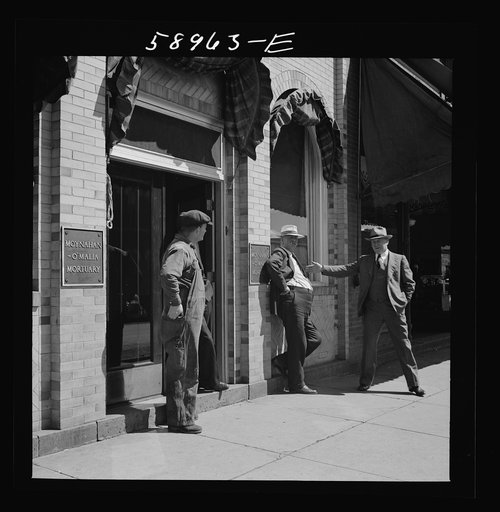 Untitled photo, possibly related to: County judge with mortician and workman in front of mortuary. Main street of Leadville, old mining town, Colorado
