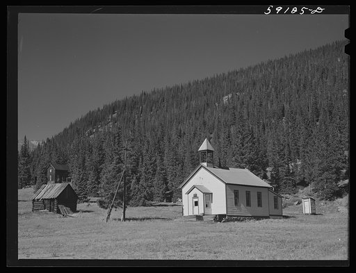 Church and houses in Montezuma, Colorado, ghost town now coming to life because of defense mining boom