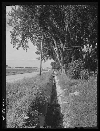 Irrigation ditch on Scottsbluff Farmsteads, FSA (Farm Security Administration) project. North Platte River Valley, Nebraska