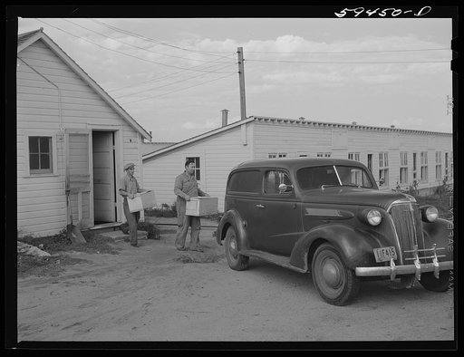 Sam Clover, in charge of poultry department, and his helper bringing in case of eggs out of the poultry house. Eggs are marketed through large cafes, restaurants and eating houses in Omaha. The demand for the co-op's premium eggs is in excess of the supply. Two Rivers Non-Stock Cooperative, Farm Sec