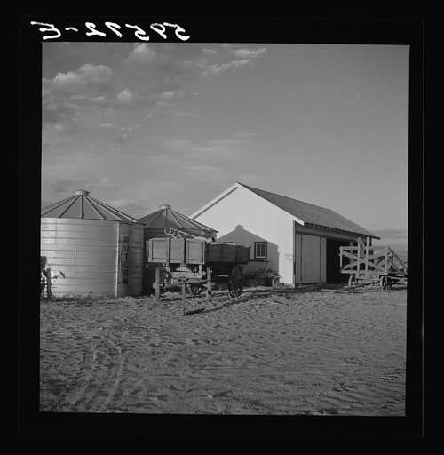Shed and grain storage bins. Cooperative association of Scottsbluff Farmsteads, FSA (Farm Security Administration) project. Scottsbluff, Nebraska