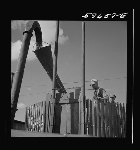 Untitled photo, possibly related to: Co-op members filling a home-made silo with corn. Two Rivers Non-Stock Cooperative Company. Waterloo, Nebraska
