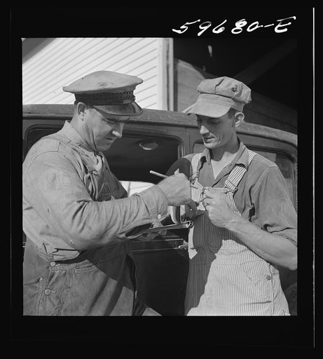 Henry Harringer, in charge of purchasing and marketing enterprise, buying oil and supplies. Two Rivers Non-Stock Cooperative Company, FSA (Farm Security Administration) co-op. Waterloo, Nebraska