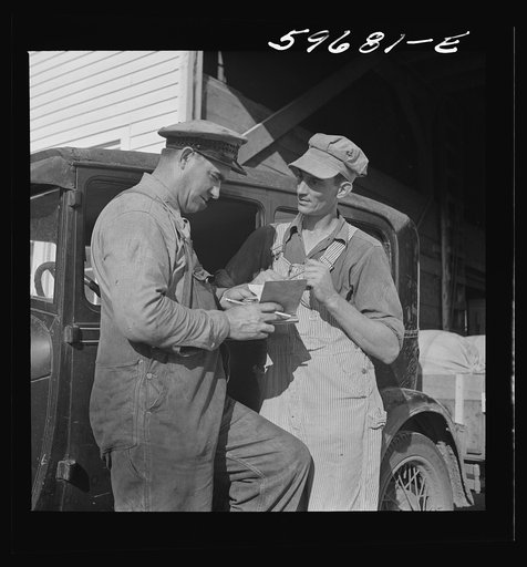 Untitled photo, possibly related to: Henry Harringer, in charge of purchasing and marketing enterprise, buying oil and supplies. Two Rivers Non-Stock Cooperative Company, FSA (Farm Security Administration) co-op. Waterloo, Nebraska