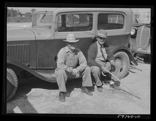 Men outside the Union Livestock Commission Company during an auction sale. Gering, Nebraska