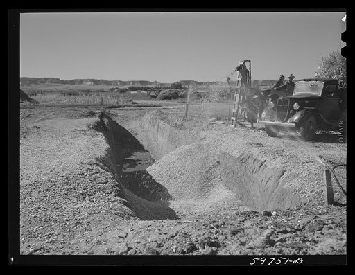 Filling the trench silo on Scottsbluff Farmsteads, FSA (Farm Security Administration) project. Scottsbluff, Nebraska