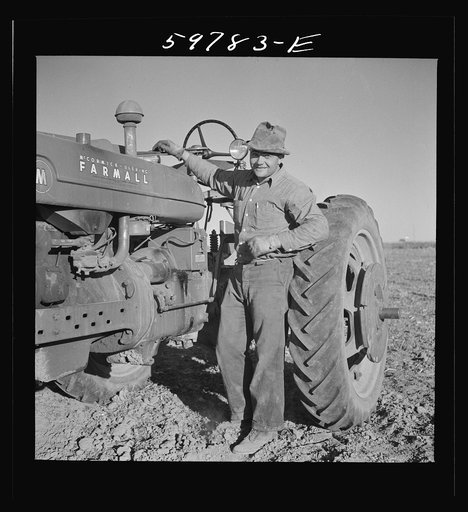 Scottsbluff homesteads, a FSA (Farm Security Administration) cooperative project in Nebraska. Frank E. Hagemeister, treasurer of the cooperative project, beside his tractor