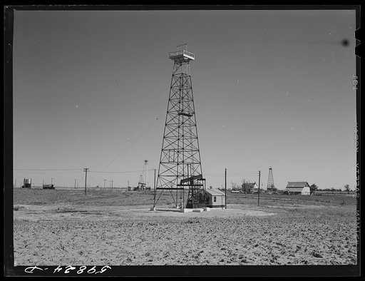 Oil well derricks and pumps in Moundridge area near McPherson, Kansas