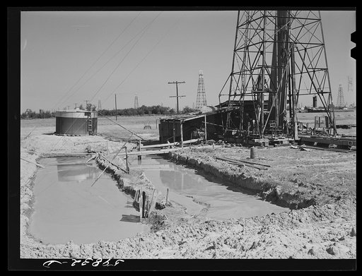 "Making a trip," pulling up old pipe to change bit on drilling pipe on the bottom of oil well at C.C. Graber pool. Continental oil company. Moundridge area near McPherson, Kansas