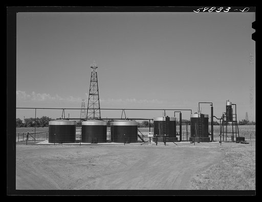 Oil well derricks and oil tanks in Moundridge area near McPherson, Kansas