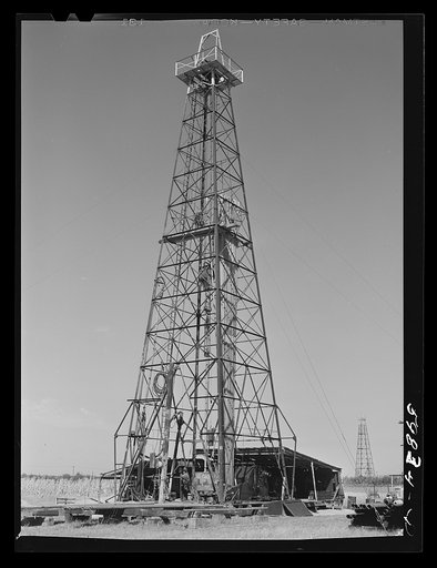 Oil well derricks and pumps in Moundridge area near McPherson, Kansas