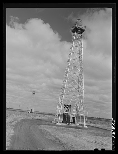 Oil well derricks and pumps in Moundridge area near McPherson, Kansas