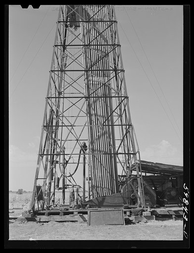 "Making a trip," pulling up old pipe to change bit on drilling pipe on the bottom of oil well at C.C. Graber pool of Continental oil company. Moundridge area near McPherson, Kansas