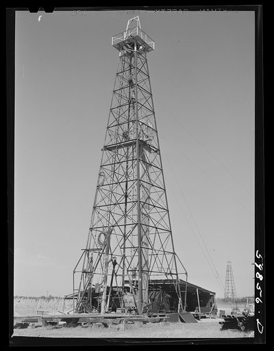 Untitled photo, possibly related to: Oil well derricks and pumps in Moundridge area near McPherson, Kansas