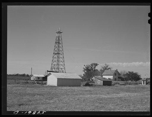 Oil well derrick in farmer's backyard. Goodrich field of Continental oil company. Valley Center Oil field near Wichita, Kansas