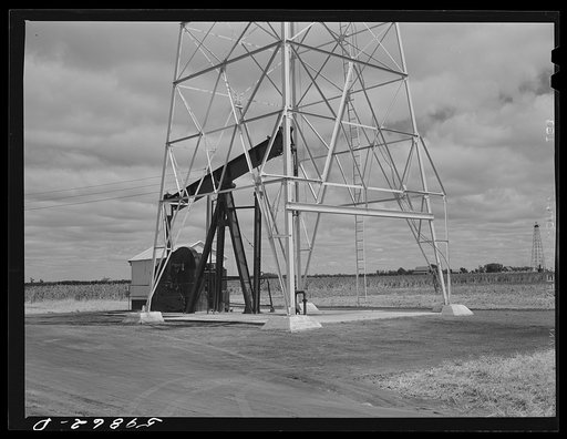 Oil well derricks and pumps in Moundridge area near McPherson, Kansas
