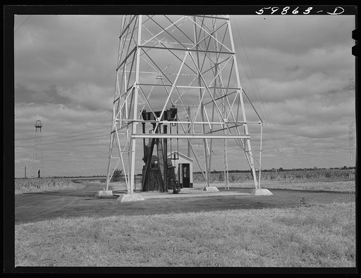 Oil well derricks and pumps in Moundridge area near McPherson, Kansas