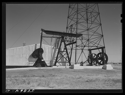 Oil well derricks and pumps in Moundridge area near McPherson, Kansas