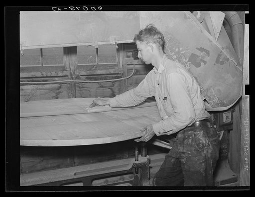 Homesteader planing a table in the woodworking shop. Tygart Valley Homesteads, West Virginia