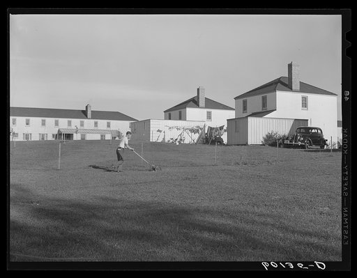 Resident of Greendale, Wisconsin, mowing lawn
