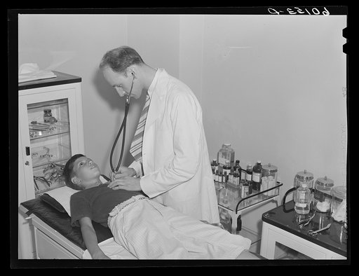 Boy being examined by doctor. Greendale, Wisconsin. This is the Greendale branch of the Milwaukee Group Health Association