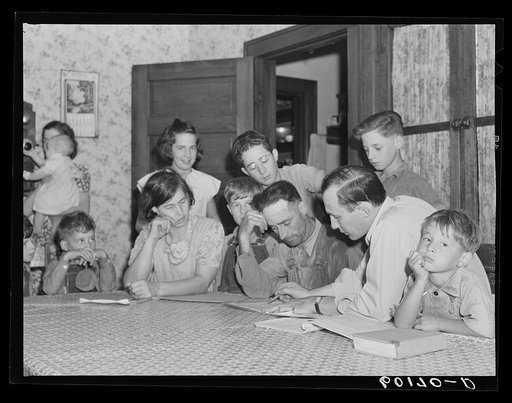 County supervisor going over farm plan with FSA (Farm Security Administration) rehabilitation borrower while family looks on. Grant County, Wisconsin