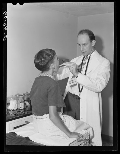 Doctor examining boy's throat. Greendale, Wisconsin. This is the Greendale branch of the Milwaukee Group Health Association