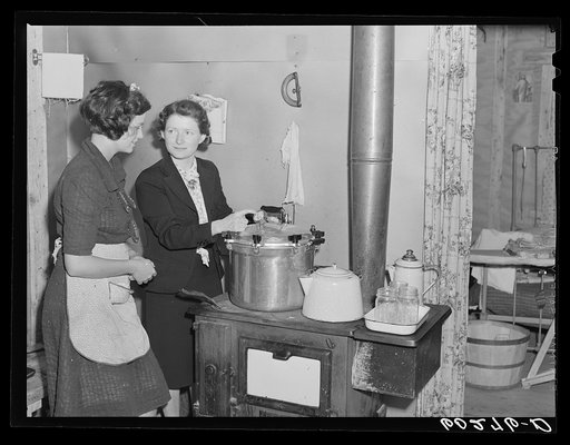 Home supervisor demonstrating use of pressure cooker to wife of rehabilitation borrower. Chippewa County, Wisconsin