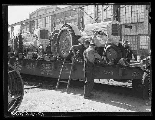 Loading tractors onto railroad car. Minneapolis-Moline Company. Minneapolis, Minnesota