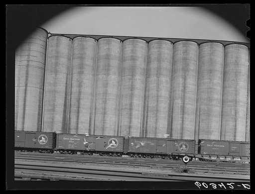 Untitled photo, possibly related to: Grain elevators with freight cars unloading. Minneapolis, Minnesota