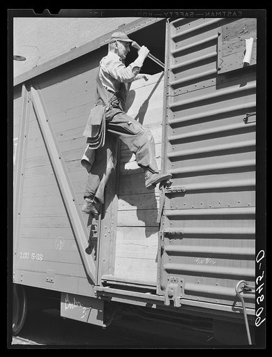 Grain sampler leaving car of wheat after getting samples. Minneapolis, Minnesota