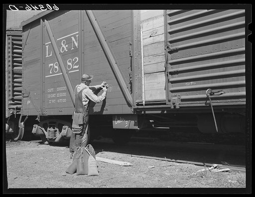 Grain sampler making out report after breaking seal of car of wheat. Minneapolis, Minnesota
