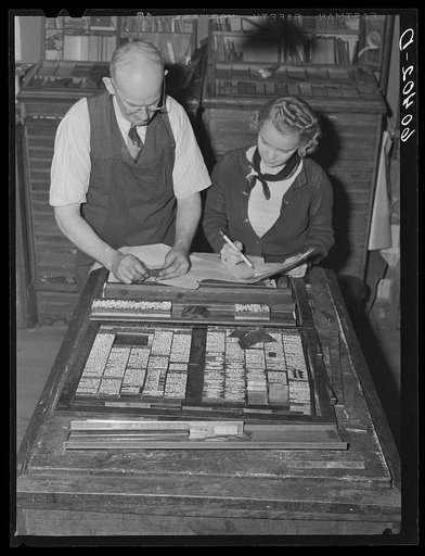 Make-up man for the Litchfield Independent helping editor of high school paper. Litchfield, Minnesota