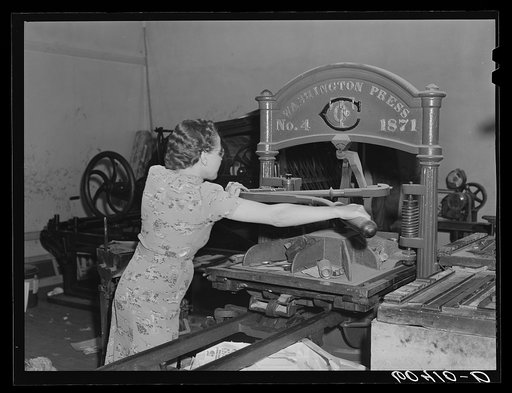 Editor of the Valley News operating hand press. Browns Valley, Minnesota