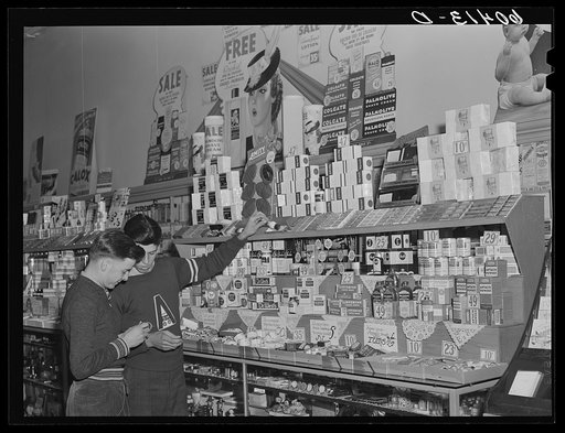 High school boys looking over shaving equipment in drug store. Graceville, Minnesota