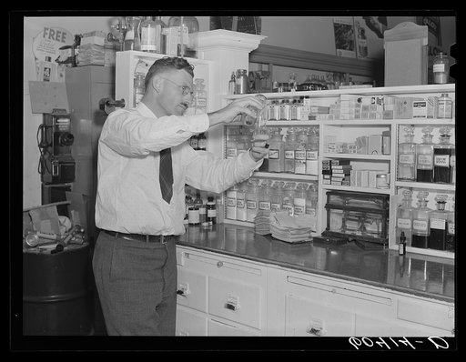 Pharmacist filling prescription. Graceville, Minnesota