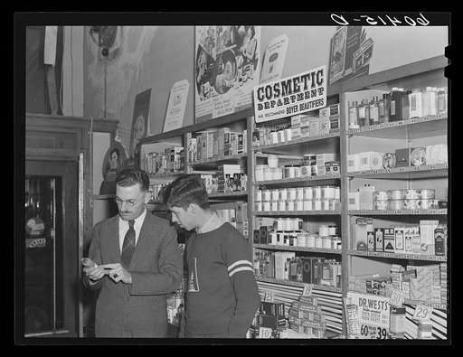 High school boy talking to druggist. Graceville, Minnesota