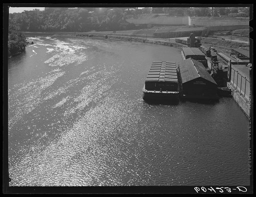 Barges on the river. Minneapolis, Minnesota. The one in the foreground is loaded with wheat for Memphis