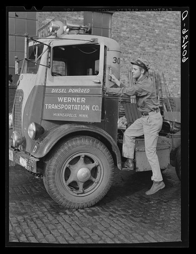 Driver entering cab of truck which has just been cleaned and checked over in garage preparatory to next trip. Minneapolis, Minnesota