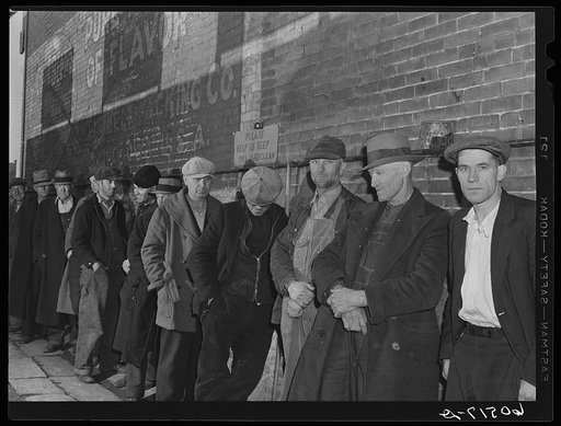 Line of men waiting in alley outside city mission. They are waiting for the meal which will be served at 5:00 p.m. Dubuque, Iowa