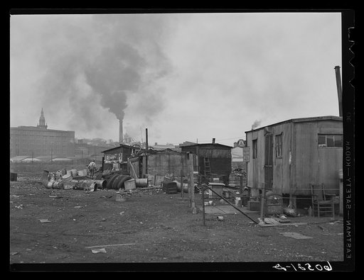 Shacks on edge of city dump, occupied by men who gain their living by salvaging of scrap iron, old tires, paper which they bale, etc. Dubuque, Iowa
