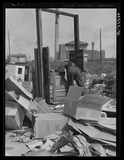 Baling papers and cardboard boxes salvaged from the city dump. Dubuque, Iowa