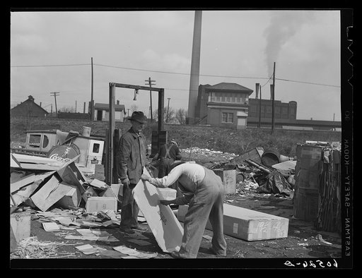 Baling papers and cardboard boxes salvaged from the city dump. Dubuque, Iowa. These men live in shacks just on the edge of the dump. Their entire income is derived from what they can pick up in their daily rounds of the dump