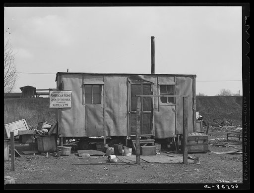 Home on the edge of the city dump. Dubuque, Iowa. This is one of the group homes occupied by single men who gain their livelihood by scouring the dump each day for scrap iron, paper boxes, which they bale and sell, and even food, grapefruit, oranges, etc., dumped by produce companies