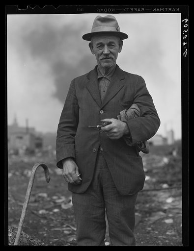 Man from river bottoms shack town, Iowa. He collects scrap iron, bits of metal, etc., from the city dump. Note the burlap sack