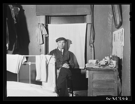 Transient farm laborer in hotel room which he rents for one dollar and fifty cents a week. Dubuque, Iowa