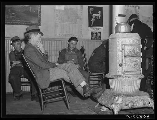 Men sitting around stove in lobby of thirty-five cents a night hotel. Dubuque, Iowa